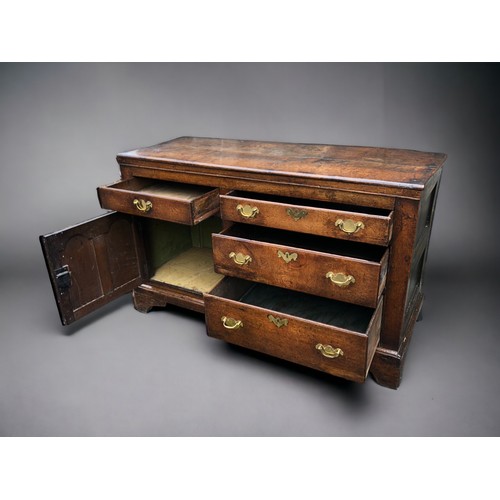 289 - AN early 18th century Oak side cupboard.
Plank top above four drawers and arched door. On bracket fe... 