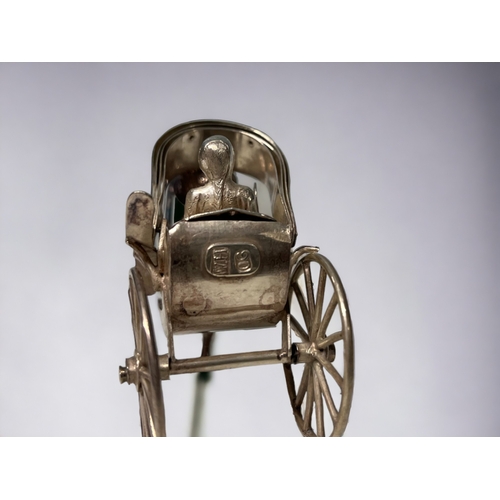 138 - A Chinese export silver miniature rickshaw & driver.
Wang Hing & co, late 19th / early 20th century.... 