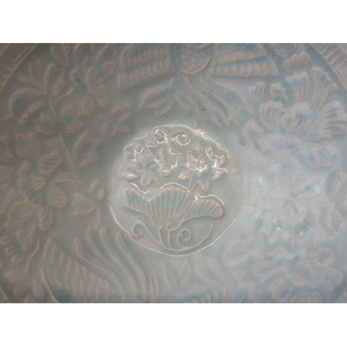 134 - A CHINESE QINGBAI PORCELAIN BOWL.
RELIEF PHOENIX & STYLISED FOLIATE DESIGN, WITH GREEK KEY BORDER.
U... 