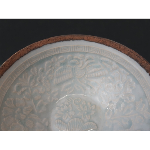 134 - A CHINESE QINGBAI PORCELAIN BOWL.
RELIEF PHOENIX & STYLISED FOLIATE DESIGN, WITH GREEK KEY BORDER.
U... 