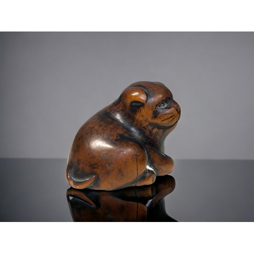 147 - A carved Boxwood 'Cat' Netsuke.
Japanese, Edo period.
Depicting a plump laying cat. 
3.2 x 4.2cm