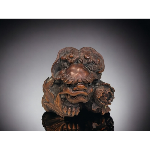 148 - A finely carved wood Shishi Lion & Peony Netsuke / Okimono. Japanese, Edo / Meiji period. Depict... 