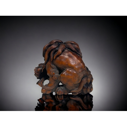 148 - A finely carved wood Shishi Lion & Peony Netsuke / Okimono. Japanese, Edo / Meiji period. Depict... 