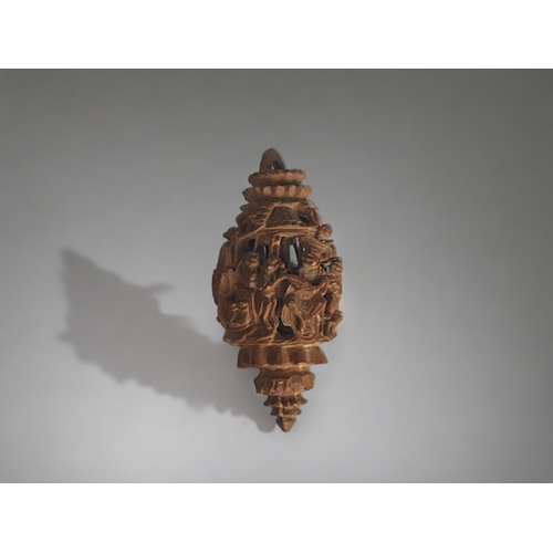 151 - A carved Hediao nut.
Chinese, Qing dynasty.
Deep carved with figures & animals. 
Length -33mm