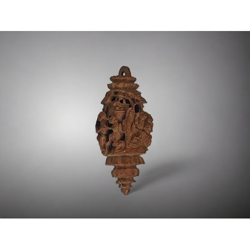 151 - A carved Hediao nut.
Chinese, Qing dynasty.
Deep carved with figures & animals. 
Length -33mm