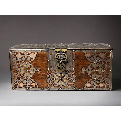 723 - A SPANISH METAL BOUND TRUNK / BOX.
Circa 1900.
Bound with stylised motifs inset with polished brass ... 