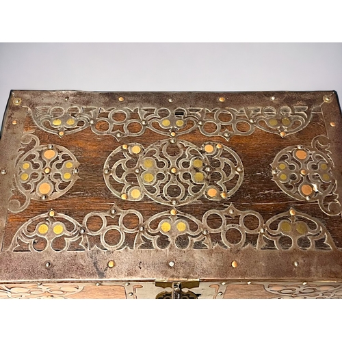 723 - A SPANISH METAL BOUND TRUNK / BOX.
Circa 1900.
Bound with stylised motifs inset with polished brass ... 