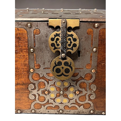 723 - A SPANISH METAL BOUND TRUNK / BOX.
Circa 1900.
Bound with stylised motifs inset with polished brass ... 