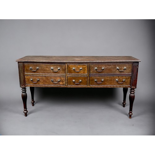 114 - A George III long Oak dresser base. With planked top and reeded legs. Two central drawers pair with ... 