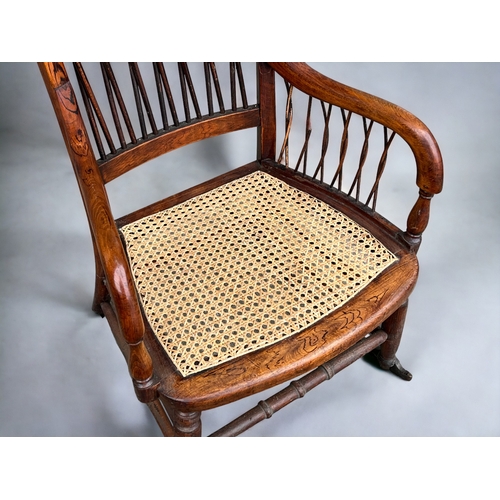 115 - A Victorian Faux Rosewood rocking armchair.
With unusual twist stick back & sides.