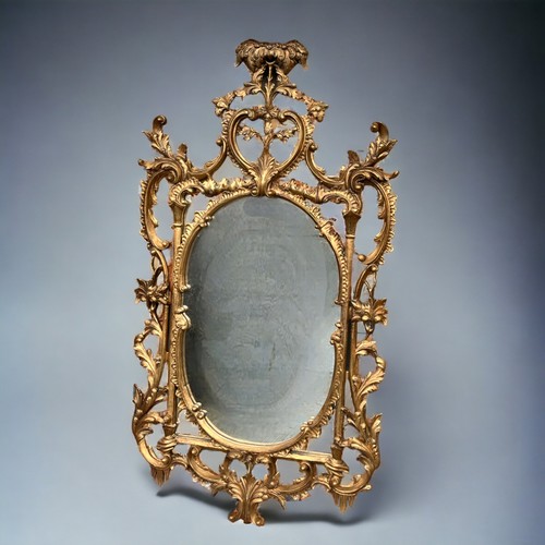 121 - A Large Italian, hand carved Gilt Wood Rococo Mirror. In the venetian style. Scrolling foliate motif... 