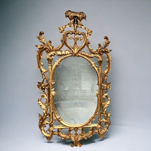 121 - A Large Italian, hand carved Gilt Wood Rococo Mirror. In the venetian style. Scrolling foliate motif... 