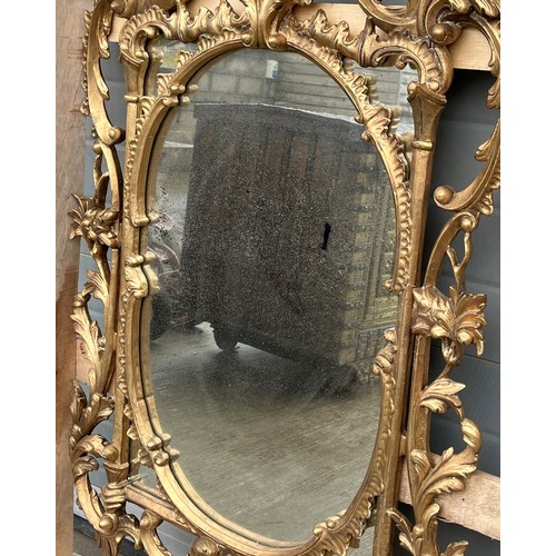 121 - A Large Italian, hand carved Gilt Wood Rococo Mirror. In the venetian style. Scrolling foliate motif... 