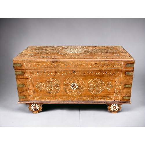 122 - A very large Syrian Teak dowry chest.Inlaid bone designs. Raised on wheels.Late 19th / early 20th ce... 