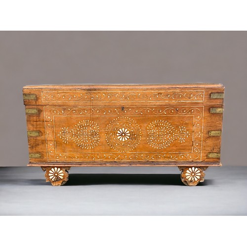 122 - A very large Syrian Teak dowry chest.Inlaid bone designs. Raised on wheels.Late 19th / early 20th ce... 