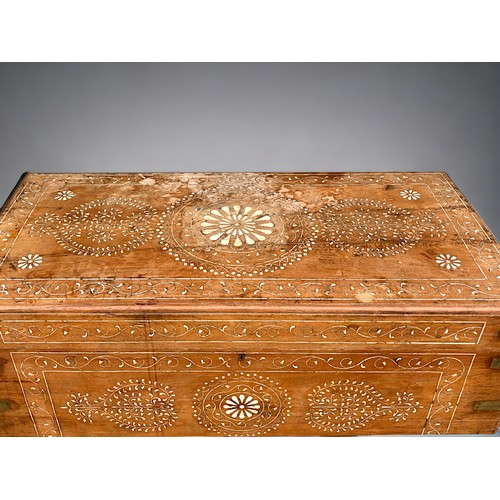 122 - A very large Syrian Teak dowry chest.Inlaid bone designs. Raised on wheels.Late 19th / early 20th ce... 