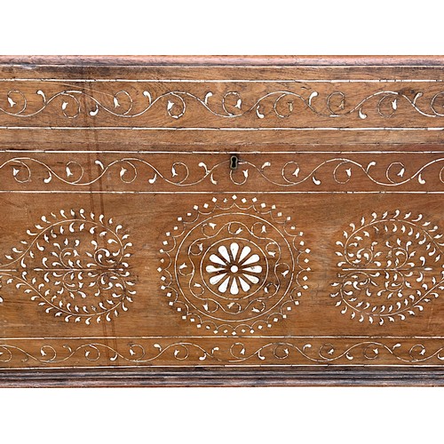 122 - A very large Syrian Teak dowry chest.Inlaid bone designs. Raised on wheels.Late 19th / early 20th ce... 