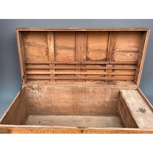 122 - A very large Syrian Teak dowry chest.Inlaid bone designs. Raised on wheels.Late 19th / early 20th ce... 