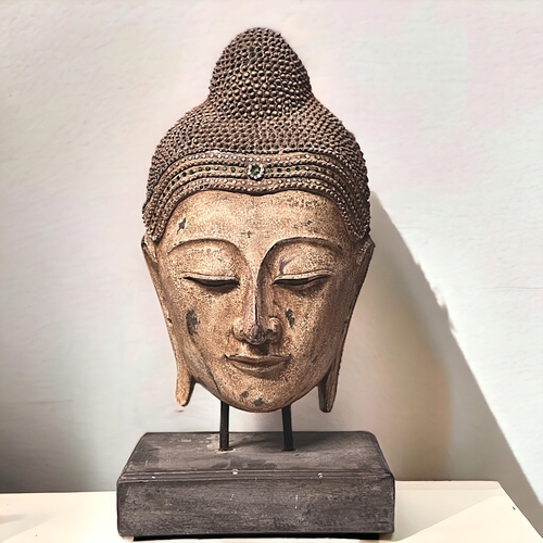 4 - A large carved wood Buddha head.Mounted on wooden stand. Clear & green glass to crown.Height - 6... 