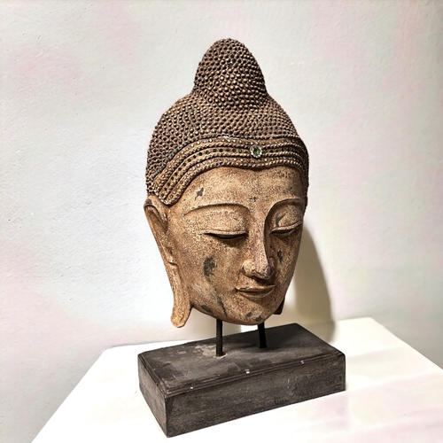 4 - A large carved wood Buddha head.Mounted on wooden stand. Clear & green glass to crown.Height - 6... 