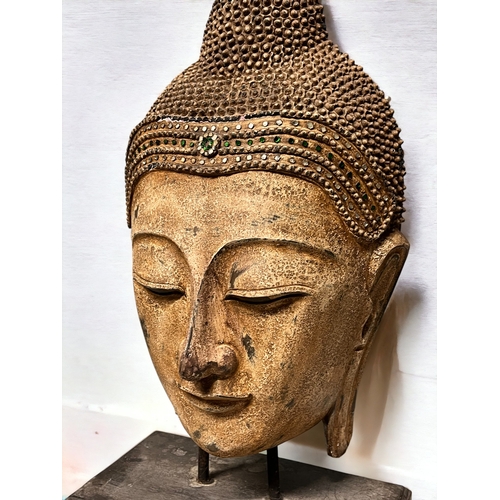 4 - A large carved wood Buddha head.Mounted on wooden stand. Clear & green glass to crown.Height - 6... 