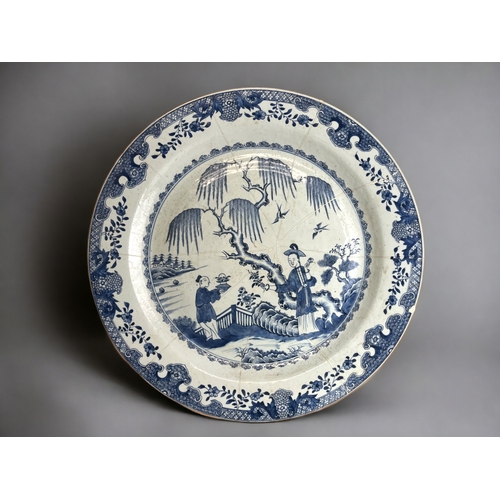 12 - A very large Chinese porcelain charger.Kangxi period (1662-1722). Blue & white painted figures i... 