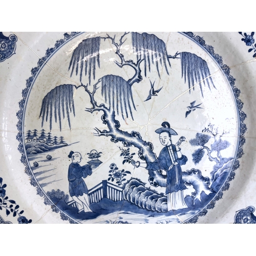 12 - A very large Chinese porcelain charger.Kangxi period (1662-1722). Blue & white painted figures i... 