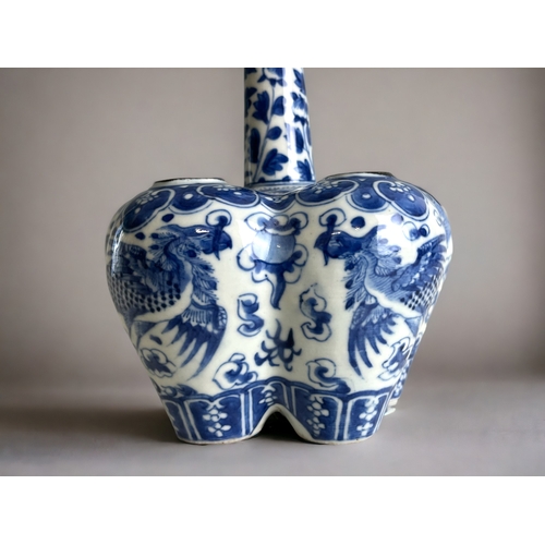 13 - A Chinese blue & white Tulip bulb vase.Qing dynasty. The lobed body, hand painted with a pair of... 