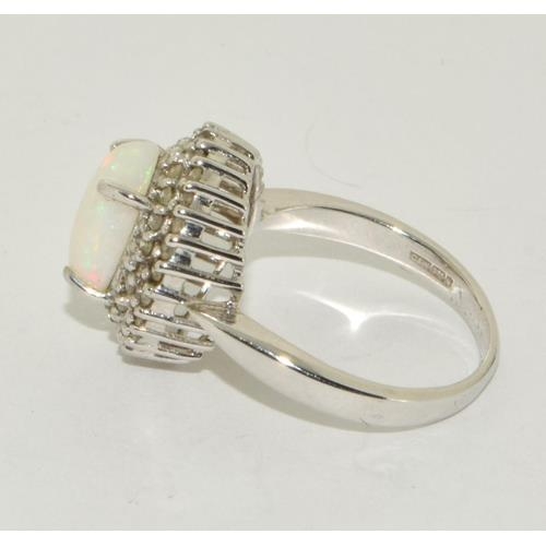 497 - 9ct white gold ladies Opal and Diamond halo design ring size M