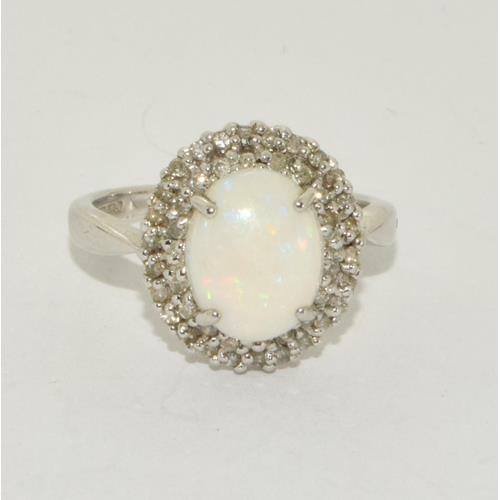 497 - 9ct white gold ladies Opal and Diamond halo design ring size M