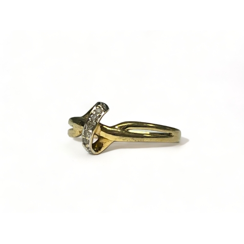 514 - A 9ct gold & diamond cross over ring. Size - k 1/2. Approx. 1.3g