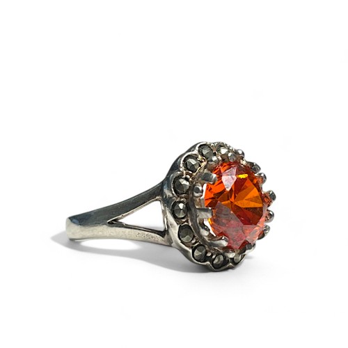 519 - A silver, Marcasite and orange stone set ladies ring. Stamped S925.