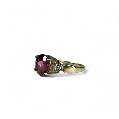 522 - A ladies 9ct Gold ring.With large central coloured stone accented with diamonds.