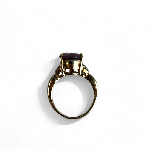 522 - A ladies 9ct Gold ring.With large central coloured stone accented with diamonds.