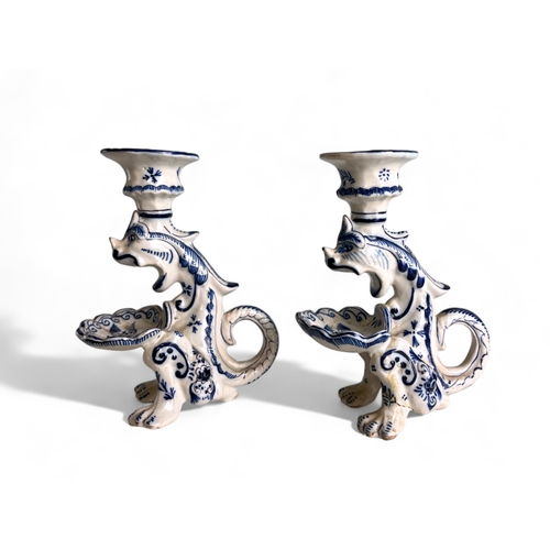 227 - A pair of Continental Delft 'Gothic' Dragon candlesticks, together with a pair of German blue & ... 