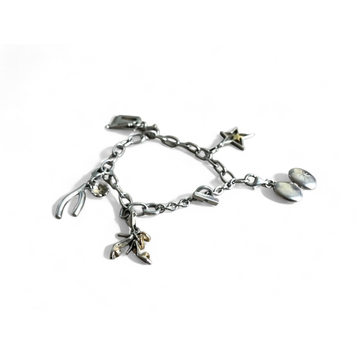 523 - A silver charm bracelet.Marked 925. Fitted with five miscellaneous charms. Weight - 22.3g... 