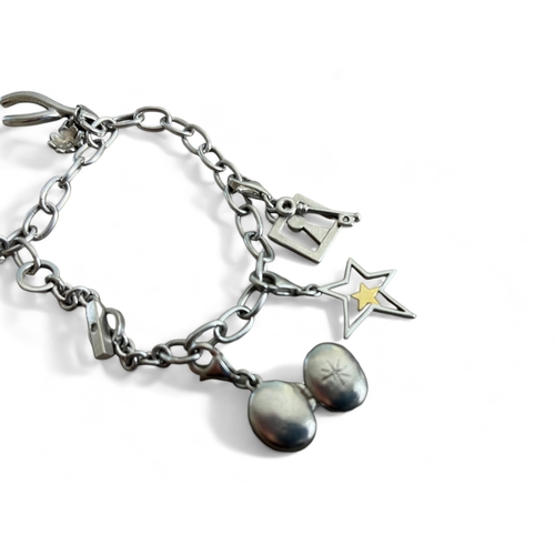 523 - A silver charm bracelet.Marked 925. Fitted with five miscellaneous charms. Weight - 22.3g... 