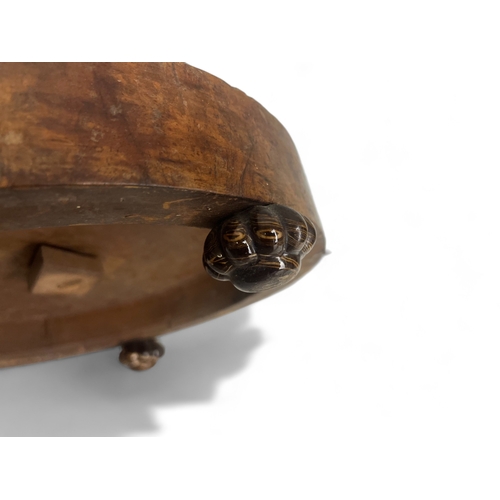 204 - A 19th century Walnut footstool. With three glazed ceramic feet.13 x 29 cm