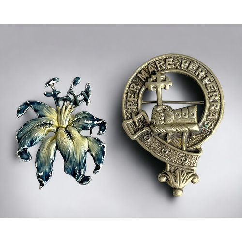 745 - A MacDonald clan crest badge together with an enamel painted flower brooch.