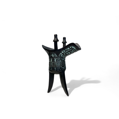 419 - A Chinese bronze tripod Jue wine cup.Archaistic style. marked to base. Height - 15.5cm