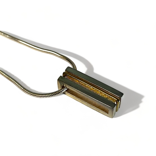 545 - A silver & yellow metal bar necklace. Stamped 