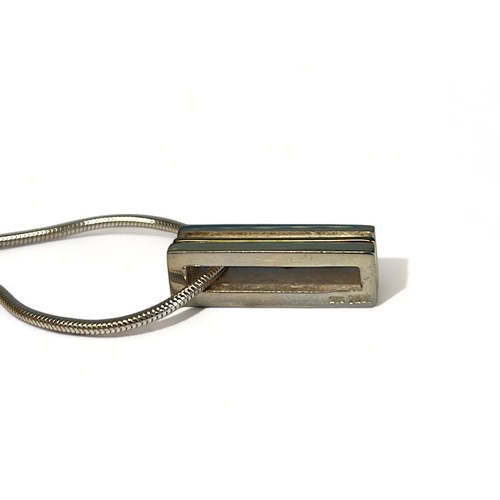 545 - A silver & yellow metal bar necklace. Stamped 