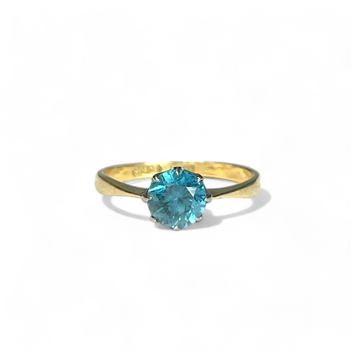 547 - A 10ct white & yellow Gold ladies solitaire ring.Set with a solitaire blue stone. Size 0 1/2... 