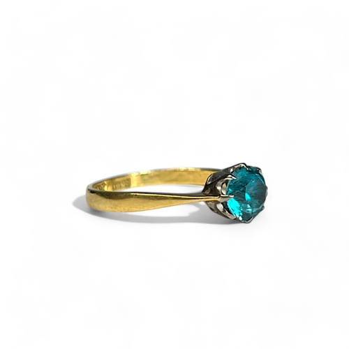 547 - A 10ct white & yellow Gold ladies solitaire ring.Set with a solitaire blue stone. Size 0 1/2... 