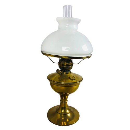 251 - Antique Brass Large oil lamp with Glass Flue and White Glass Shade.Height 56cm to Top of Flue.