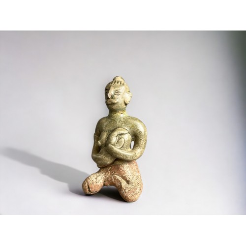 34 - A Sukothai Sawankhalok Celadon figure.Thailand, 14th-15th century.Seated mother with child. Height -... 