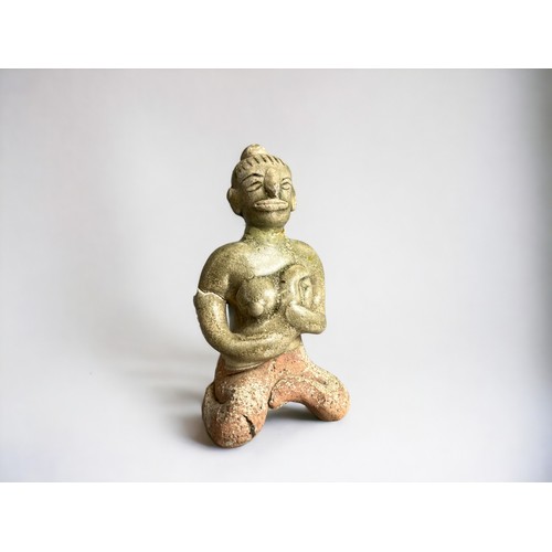 34 - A Sukothai Sawankhalok Celadon figure.Thailand, 14th-15th century.Seated mother with child. Height -... 