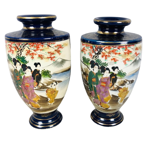 65 - Two Japanese Satsuma cobalt blue ground with geisha and landscape decoration Vases