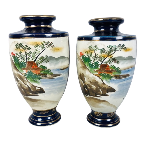 65 - Two Japanese Satsuma cobalt blue ground with geisha and landscape decoration Vases