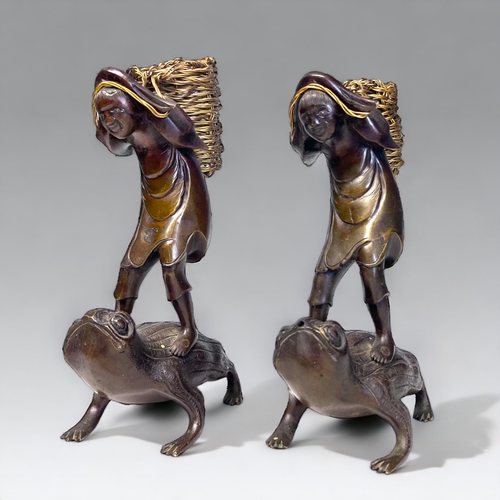 35 - A PAIR OF JAPANESE BRONZE OKIMONO. Meiji period. Depicting men stood on the backs of toads, carrying... 